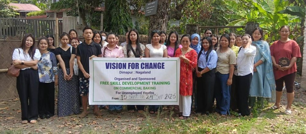 Participants pose with a banner during the free skill development training on commercial baking organized by Vision for Change, Dimapur, at Lufemy Baking Centre.